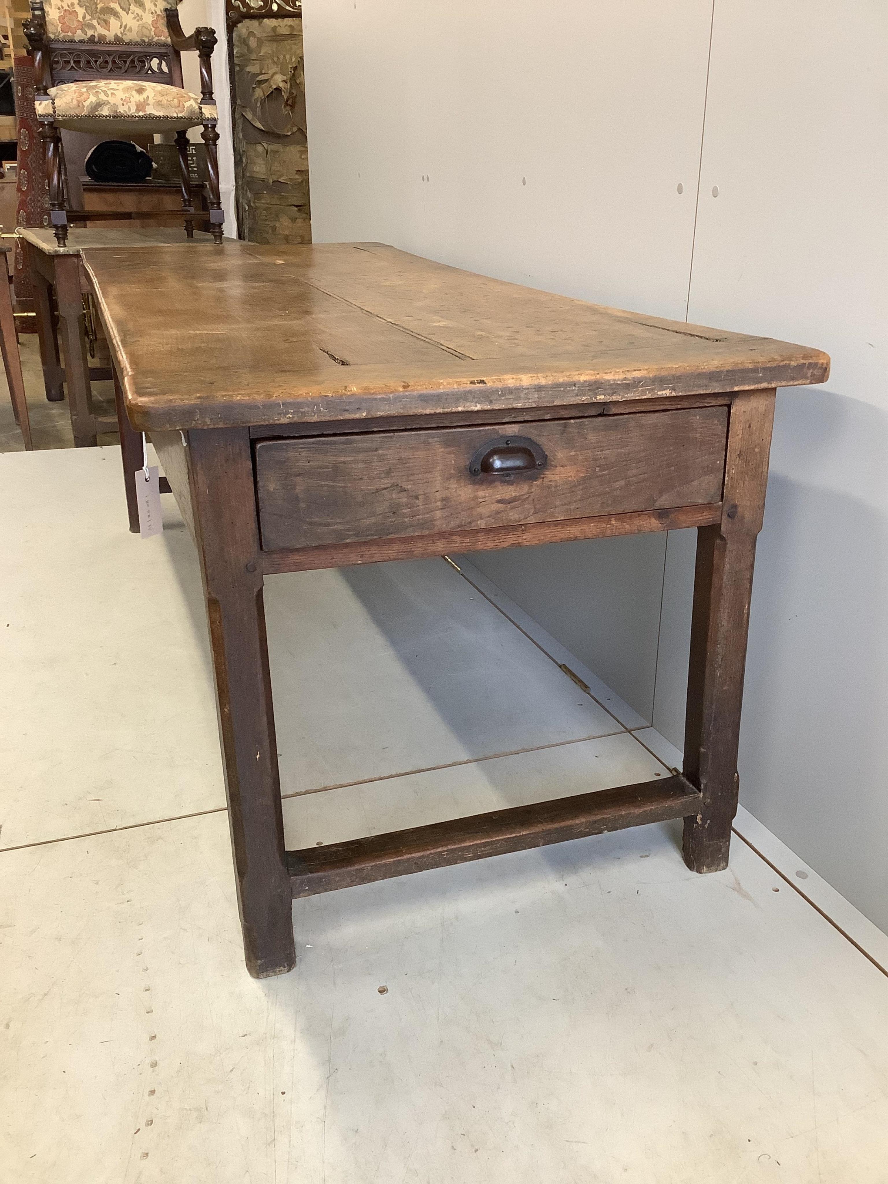 A 19th century French fruitwood three drawer kitchen table with cleated twin plank top, width 193cm, depth 79cm, height 72cm. Condition - fair